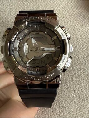 G-Shock GM-110 silver case analog-digital watch with navy blue band.